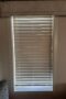 Venetian blinds closed over window