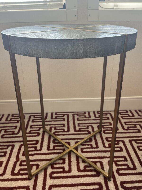 Side round table with grey top and gold frame.