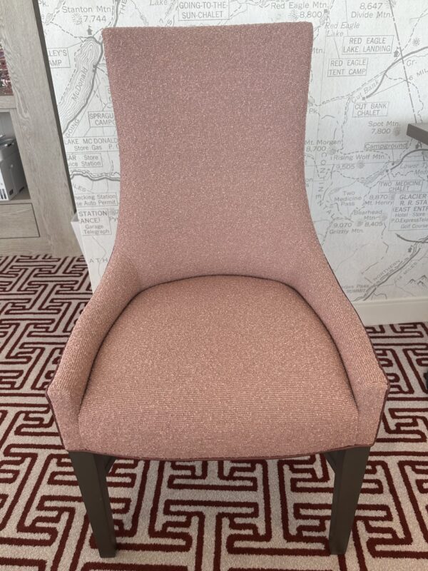 Pink chair, no arms in game room.