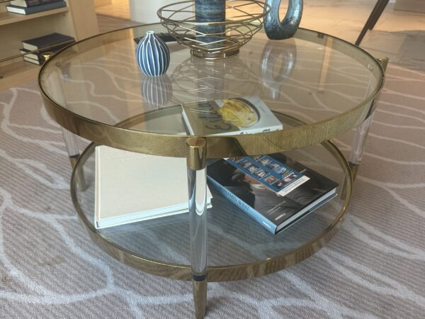 Clear glass coffee table with brass edges and legs, two tiers of glass