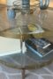 Clear glass coffee table with brass edges and legs, two tiers of glass