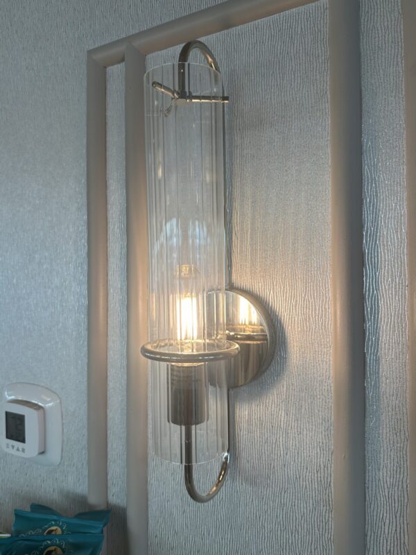 Wall mounted light fixture with glass covering.