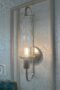 Wall mounted light fixture with glass covering.