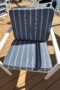Outdoor armchair, navy blue with white stripes.