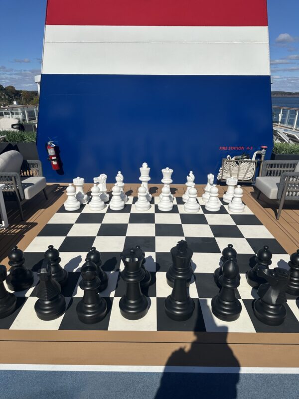 Large outdoor chess board with pieces about two feet tall