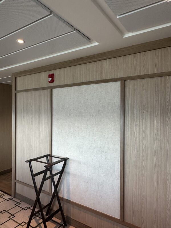 White twill wall covering framed by light maple wood with waiters collapsing stand